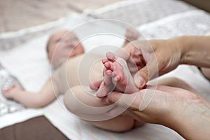 Person massaging the baby foot