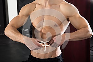 Person Measuring His Body Fat With Caliper