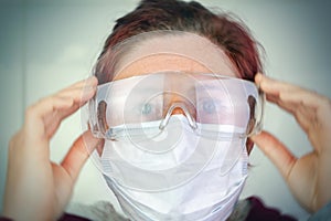 Person with medical mask and protective glasses for protection against flu and diseases