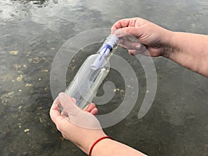 A person with a message in a crystal bottle