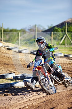 Person, motorcycle and dirt race track competition as .professional in action, danger or fearless risk. Bike rider, off