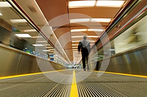 Person on moving travelator