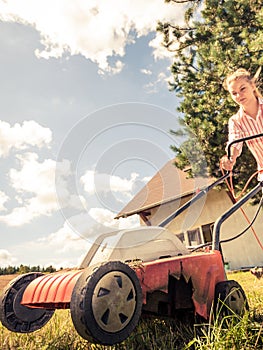 Person mowing green grass