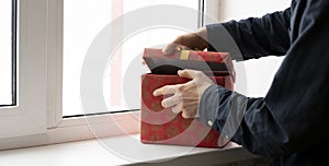 a person open the gifted present box and check whats inside, surprise on the holidays