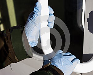 Person opens the door in medical gloves on the background of the coronavirus pandemic.