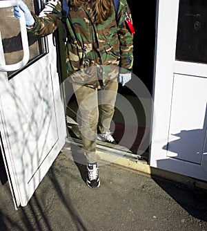 Person opens the door in medical gloves on the background of the coronavirus pandemic.