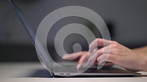 Person opens the laptop. Unrecognizable woman working on computer.