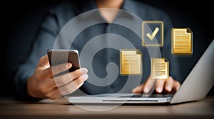 Person managing digital documents using phone and laptop