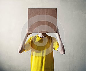 Person with overhead a cardboard box