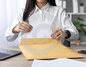 Person Packing Documents in Office Environment