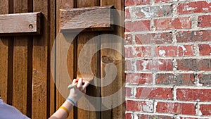 Person painting shutters on house