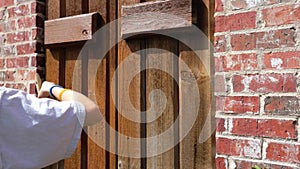 Person painting shutters on house