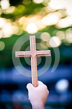 Person palm hands to hold holy cross, crucifix to worship.