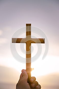 person palm hands to hold holy cross, crucifix to worship.