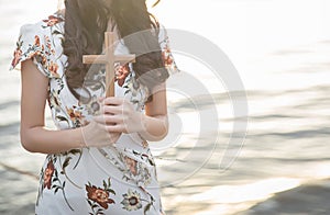 Person palm hands to hold holy cross, crucifix to worship.