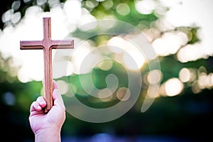 Person palm hands to hold holy cross, crucifix to worship.