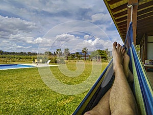 Person on paraguayan hammock at countryside landscape