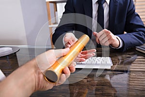 Person Passing Baton To Businessperson