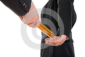 Person passing a golden relay baton to another person