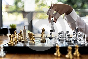 Person playing chess board game, business woman concept image holding chess pieces like business competition and risk management,