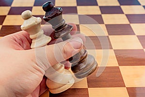 Person playing chess game making a move