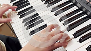 A person playing a double keyboard electronic organ.