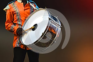 A person playing Drumhead, -Drumhead is a musical instrument that is sounded by being struck or scraped by a beater photo