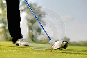 Person playing golf, low section
