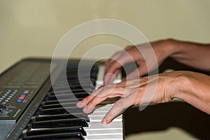 person playing with his hands the keys of a professional piano