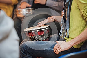 Person playing on Jambe Drum no face