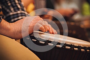 Person playing on Jambe Drum no face