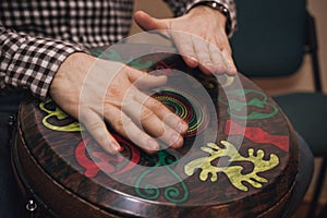 Person playing on Jambe Drum no face