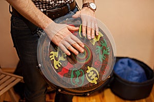 Person playing on Jambe Drum no face
