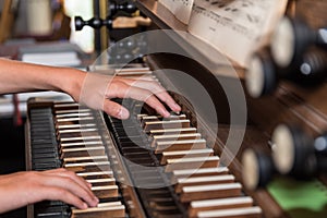 Person plays church organ - detail
