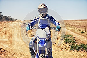 Person, portrait and motorcyclist on dirt bike for extreme sports, outdoor competition or race. Expert or professional