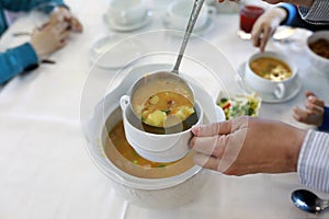 Person pouring soup