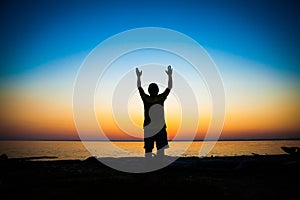 Person Praying at Sunset