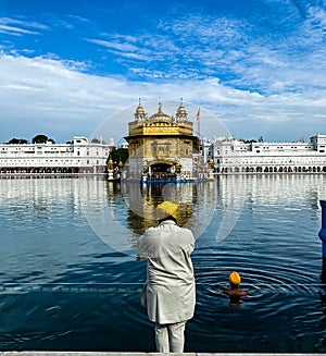 A person prays at Golden Temple amristar with folding hands photo
