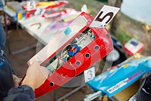 Person prepare toy ship before racing near the photo