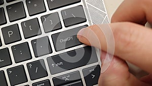A person pressing a keyboard key with the word ChatGPT