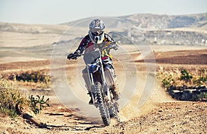 Person, professional motorcyclist and dirt track for race, extreme sports or outdoor competition. Expert rider on