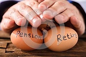 Person Protecting Egg Showing Pension And Retirement Text