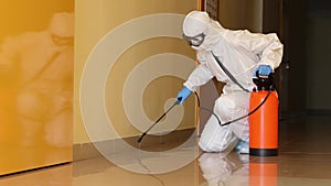 Person in protective suit mask and goggles disinfects corridors indoors 4k movie