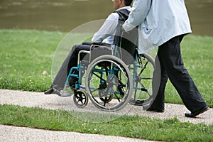 Person pushing a disabled person