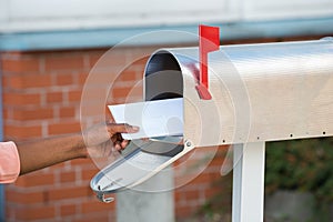 Person Putting Letters In Mailbox