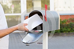 Person Putting Letters In Mailbox