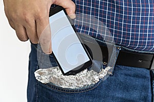 Person putting a smartphone in his pocket covered with foil