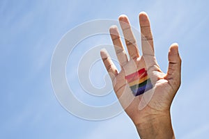 Person with a rainbow flag in his or her hand