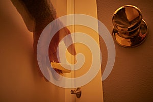 Person reaching out for doorknobs and handles