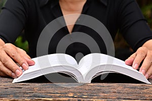 Person read the book on wooden table